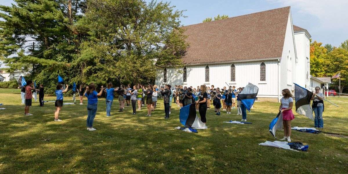 high school students from Greenville High School marching band perform a concert and flag show on the museum grounds